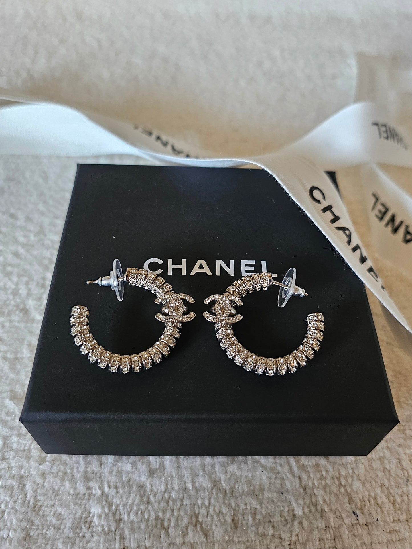 Chanel small hoops, silver with stones.