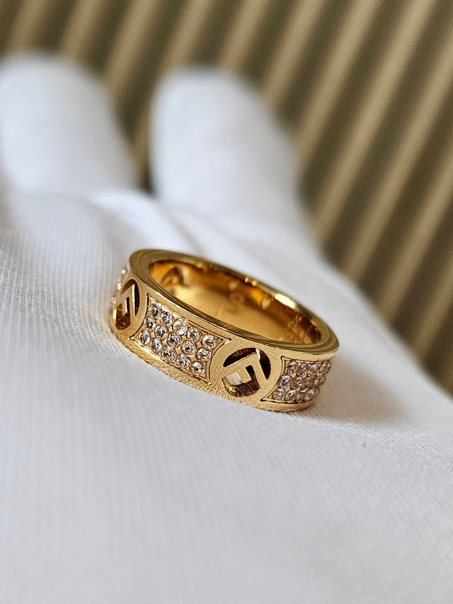 F- Fendi ring in golden with stones.