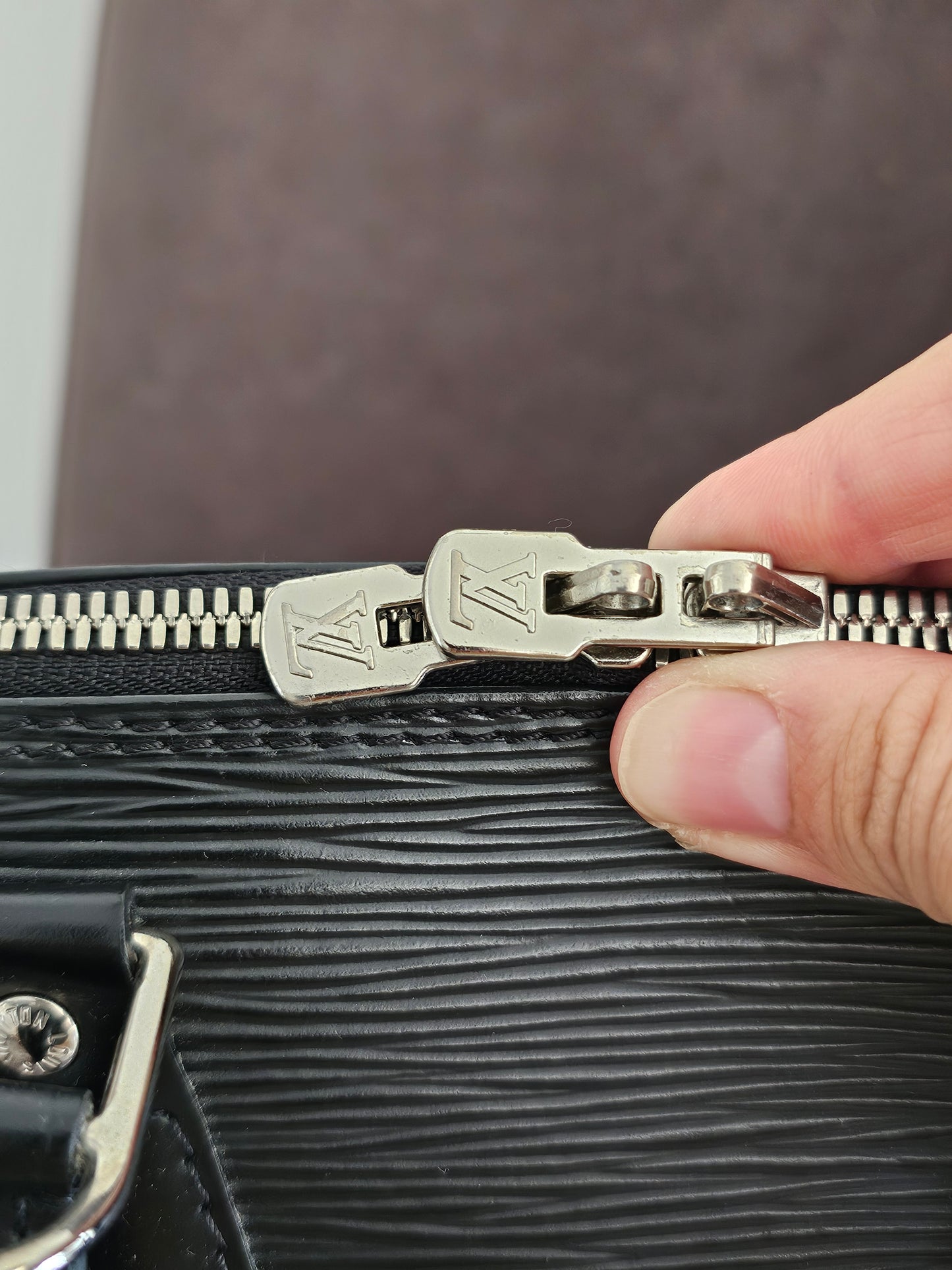 Louis Vuitton Alma PM with adjustable shoulder strap.