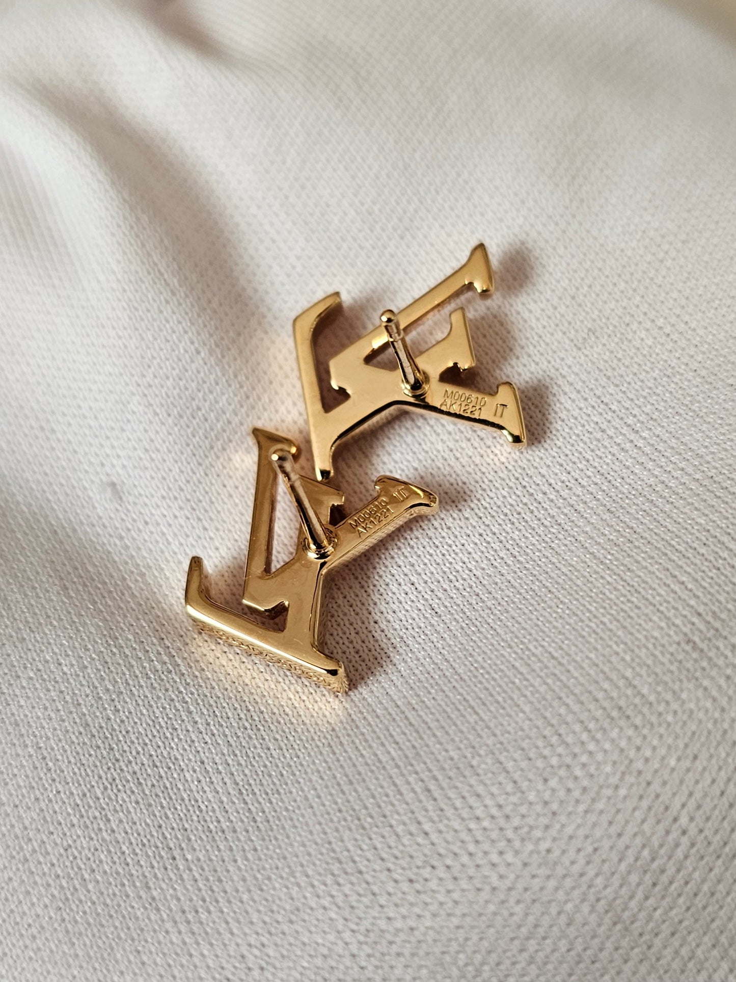 Louis Vuitton , iconic LV earrings, golden.