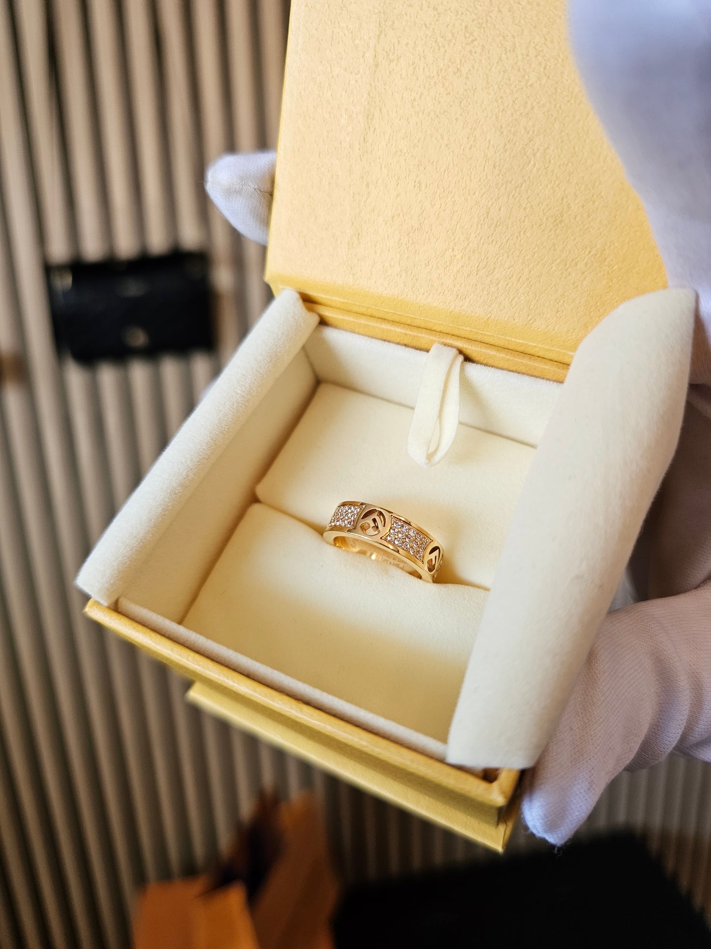 F- Fendi ring in golden with stones.