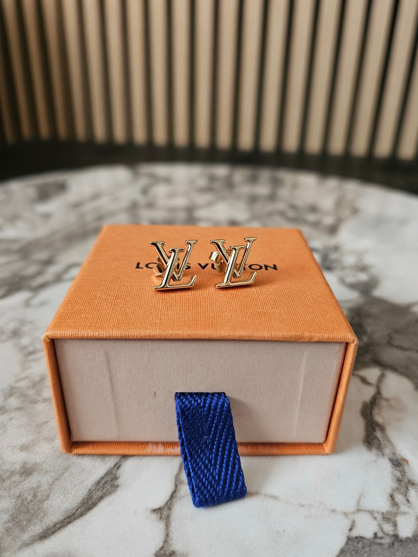 Louis Vuitton , iconic LV earrings, golden.