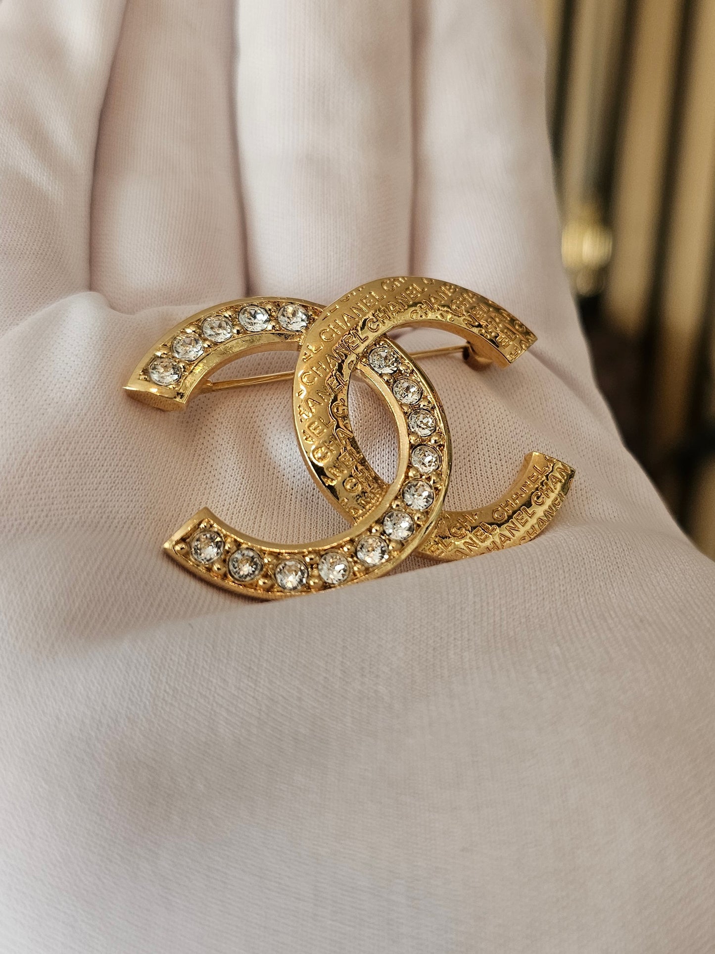 Chanel golden broche with stones and Chanel.