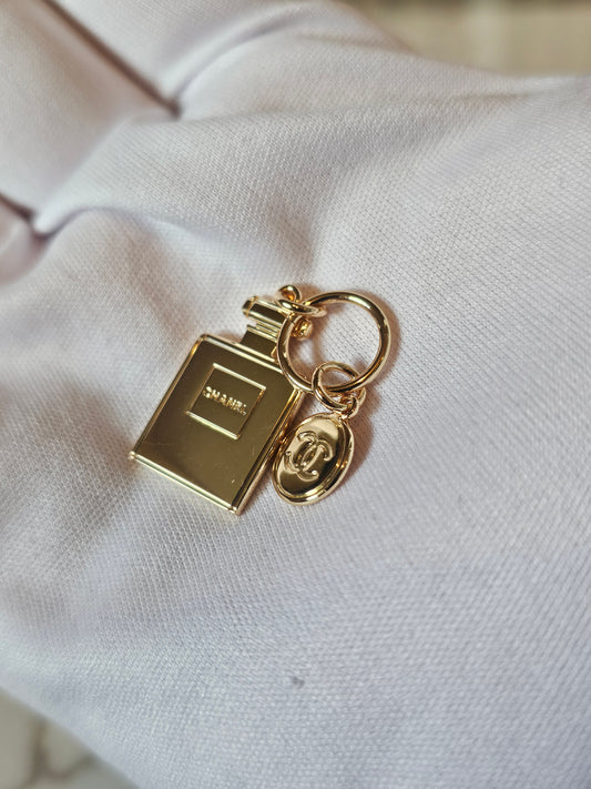 Chanel mini bag charm. Golden perfume bottle.