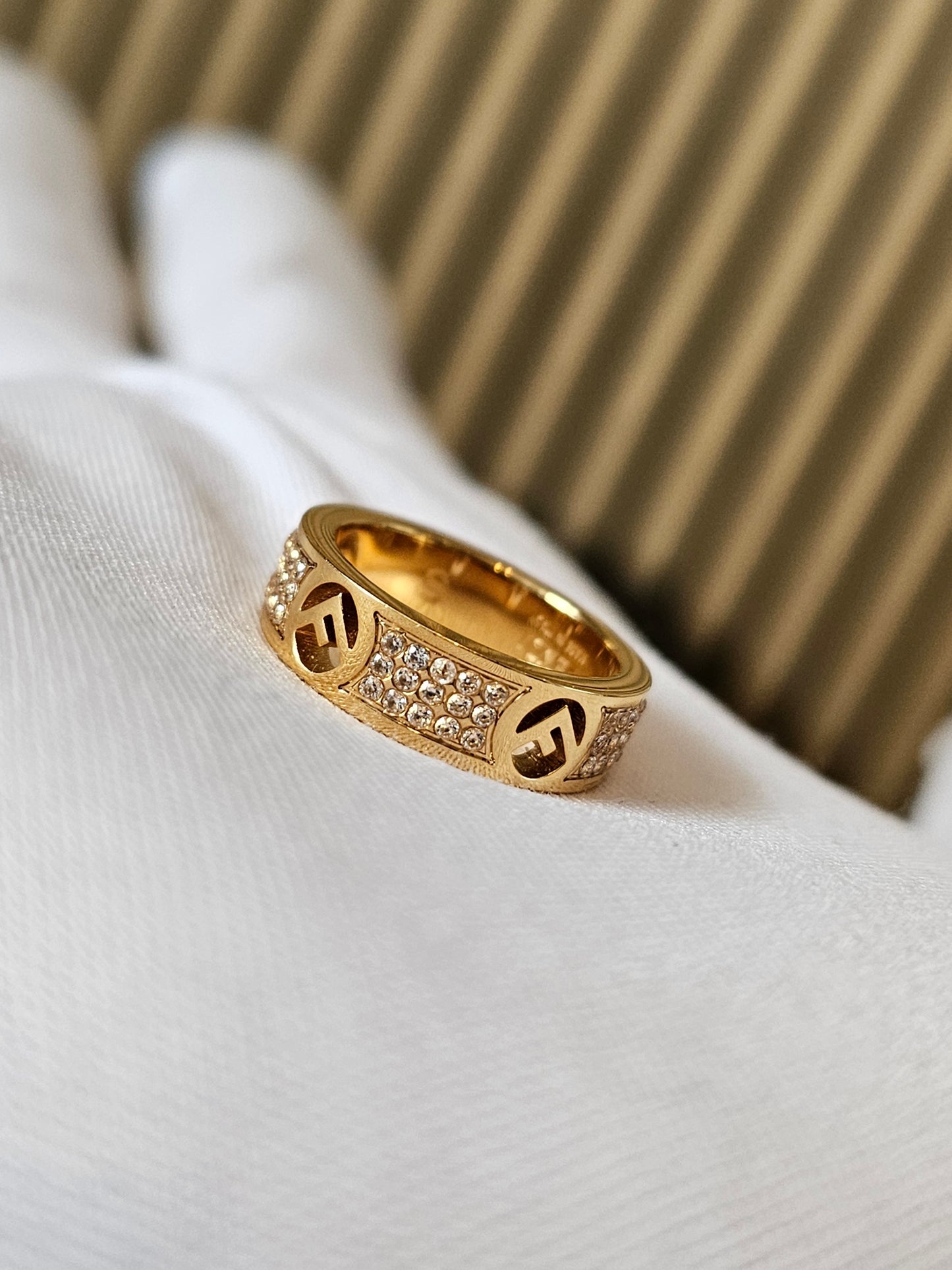 F- Fendi ring in golden with stones.