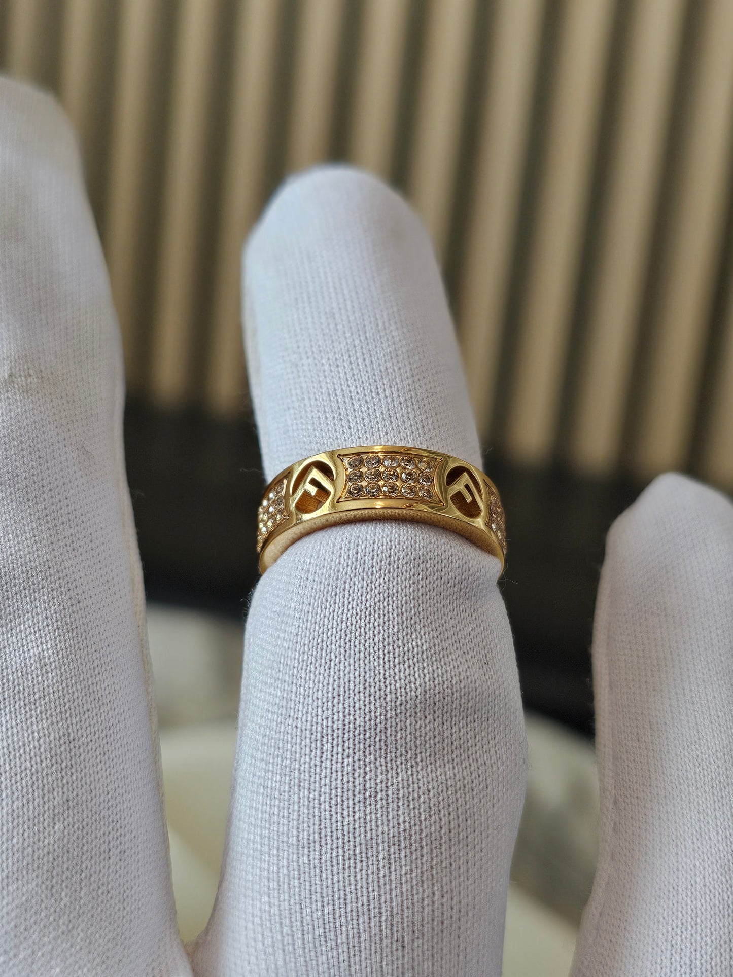 F- Fendi ring in golden with stones.