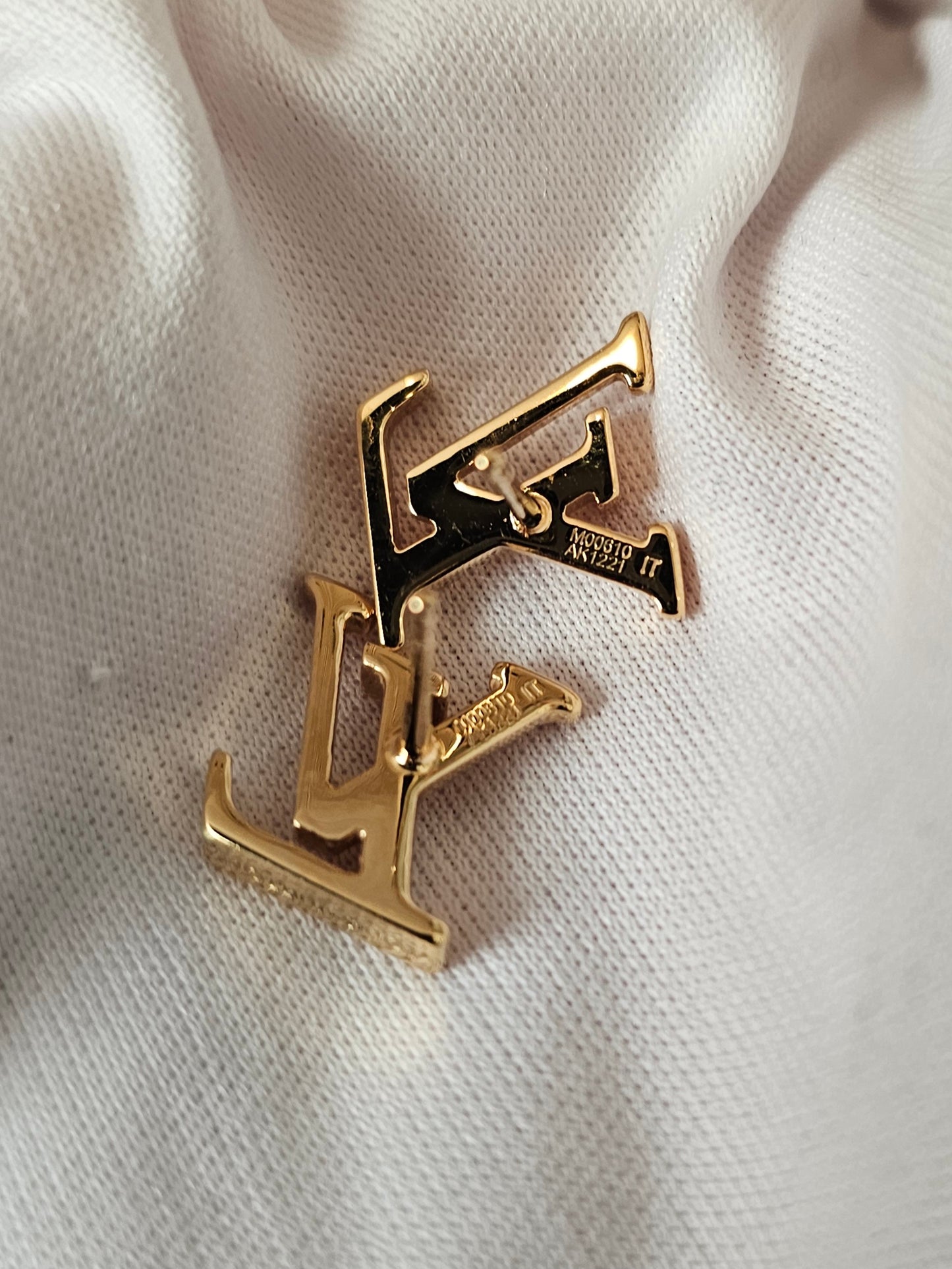 Louis Vuitton , iconic LV earrings, golden.