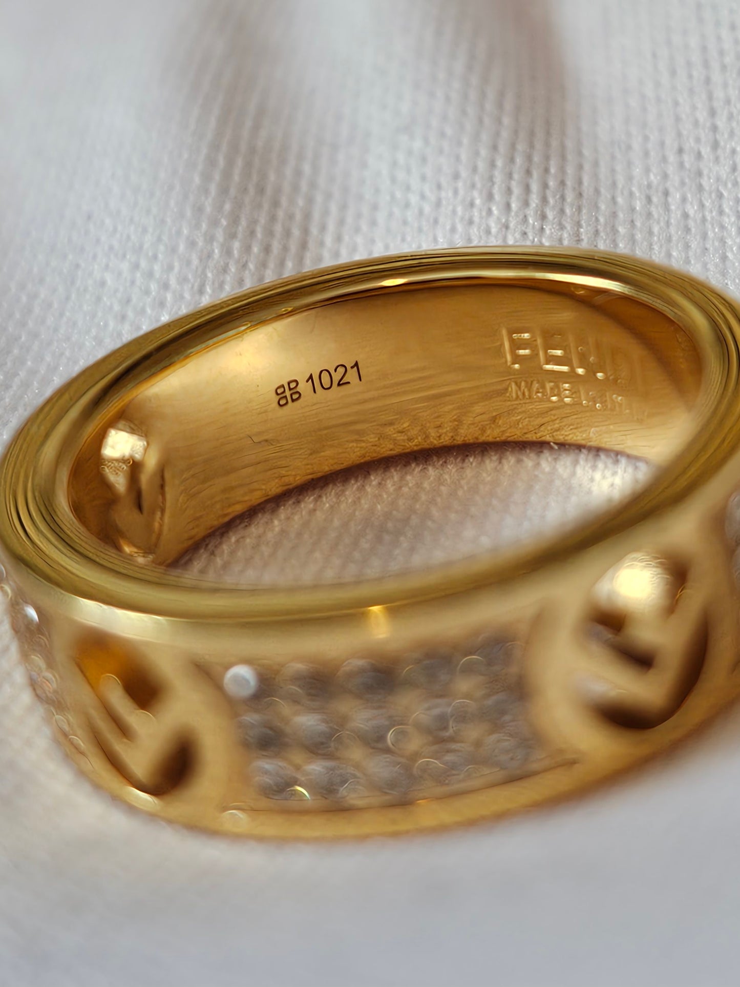 F- Fendi ring in golden with stones.