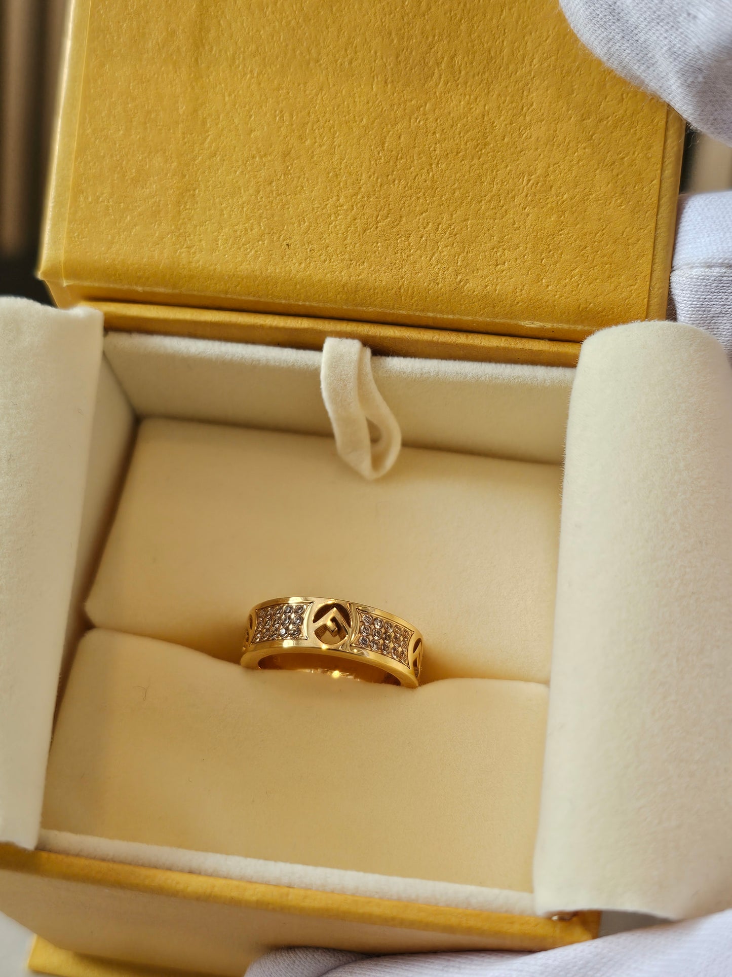 F- Fendi ring in golden with stones.