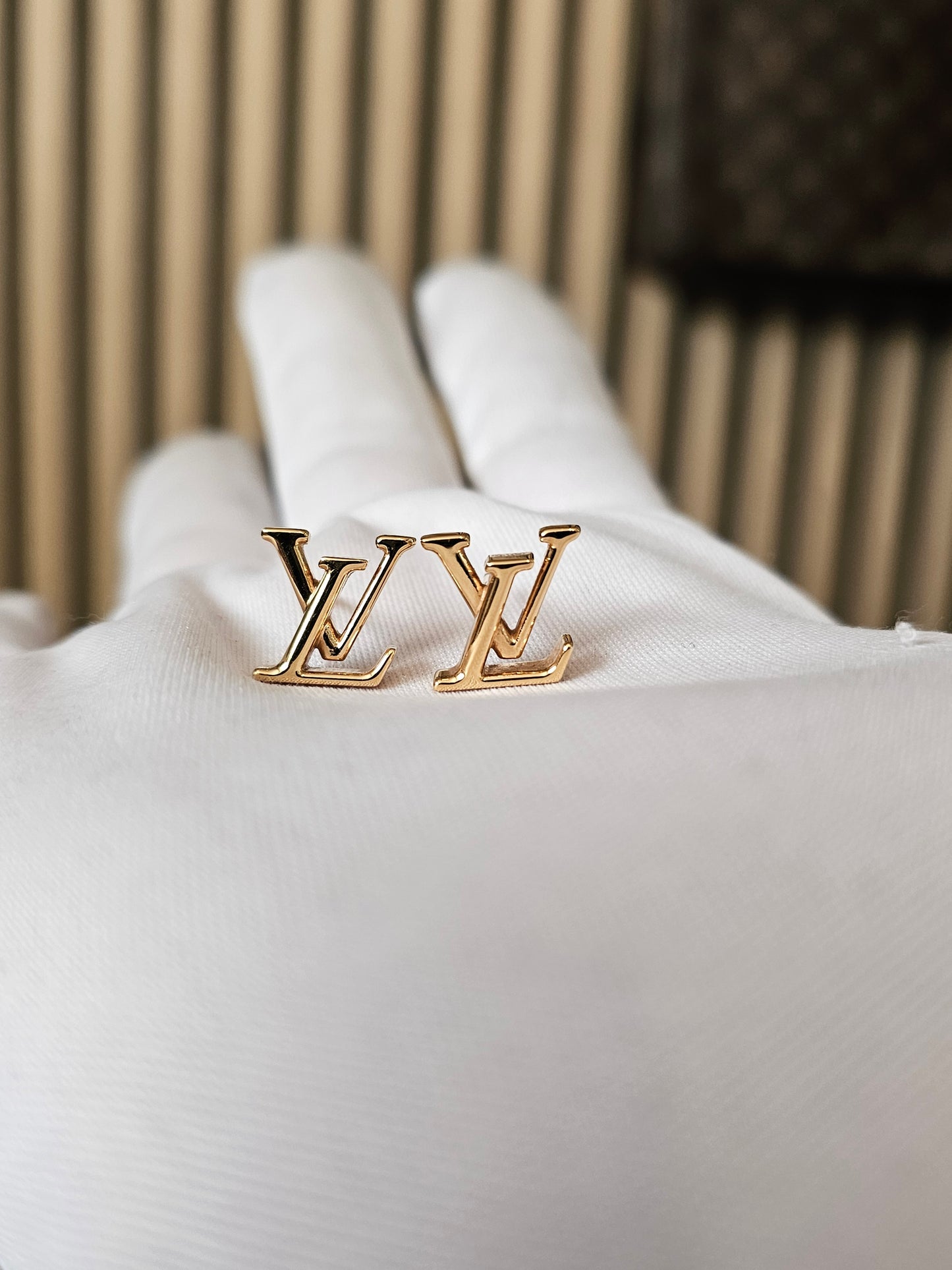 Louis Vuitton , iconic LV earrings, golden.