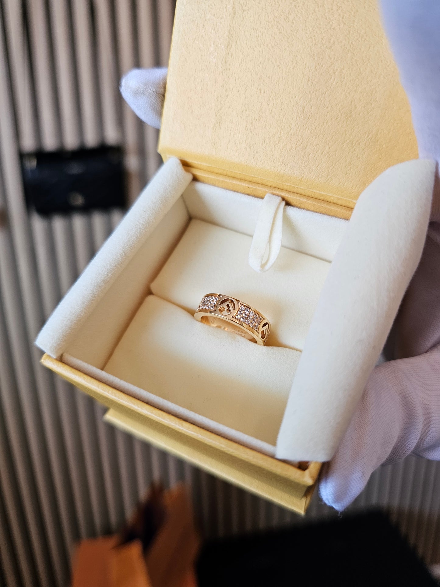 F- Fendi ring in golden with stones.