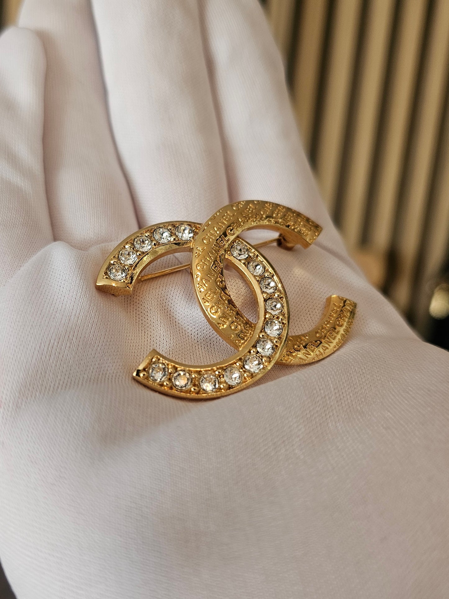 Chanel golden broche with stones and Chanel.
