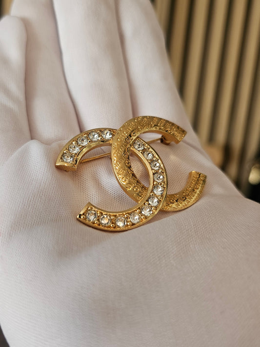 ABD023 - Chanel golden broche with stones and Chanel.