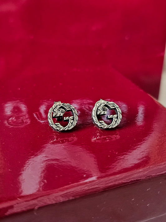 Gucci silver GG interlocking earrings.