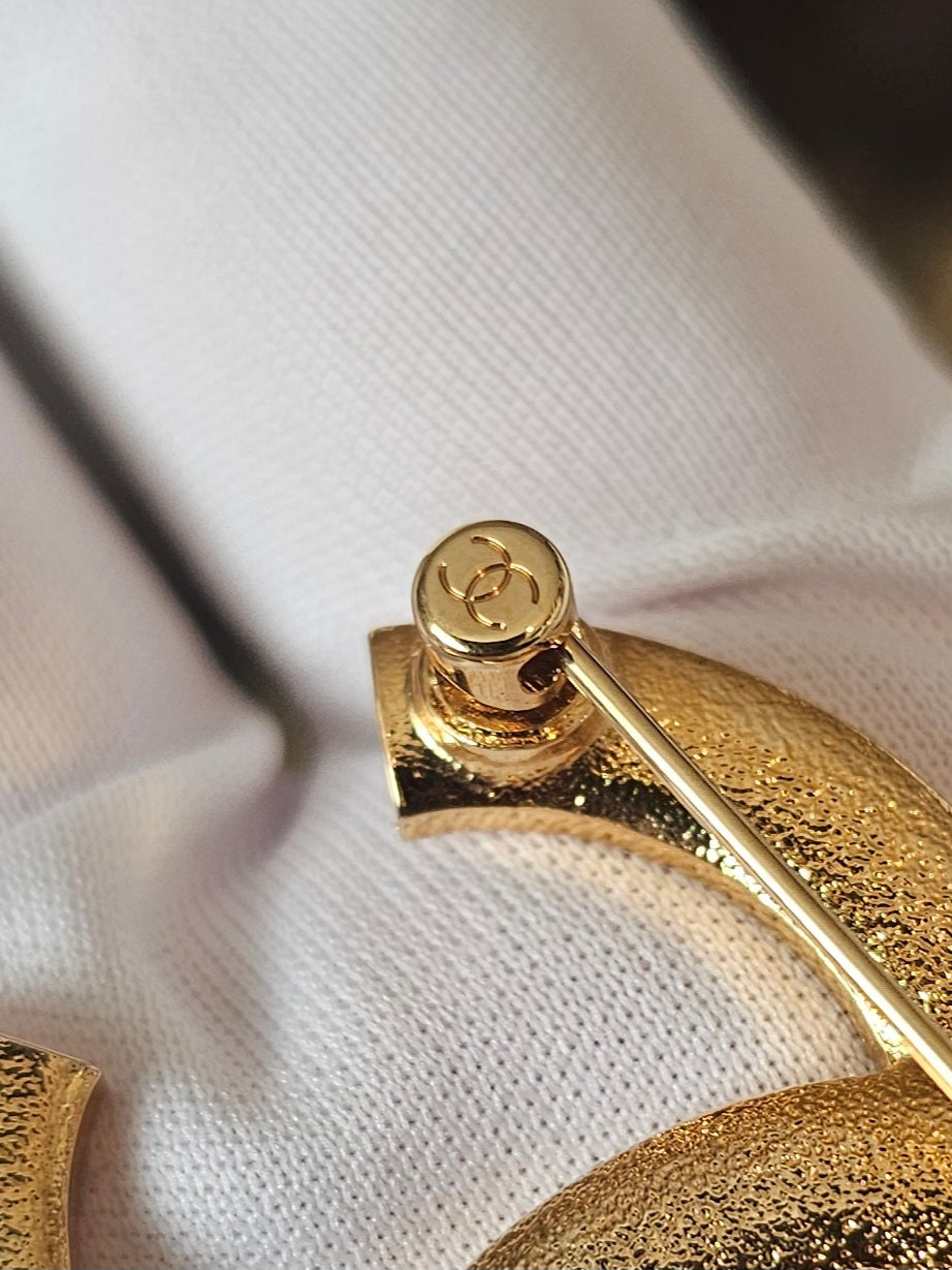Chanel golden broche with stones and Chanel.