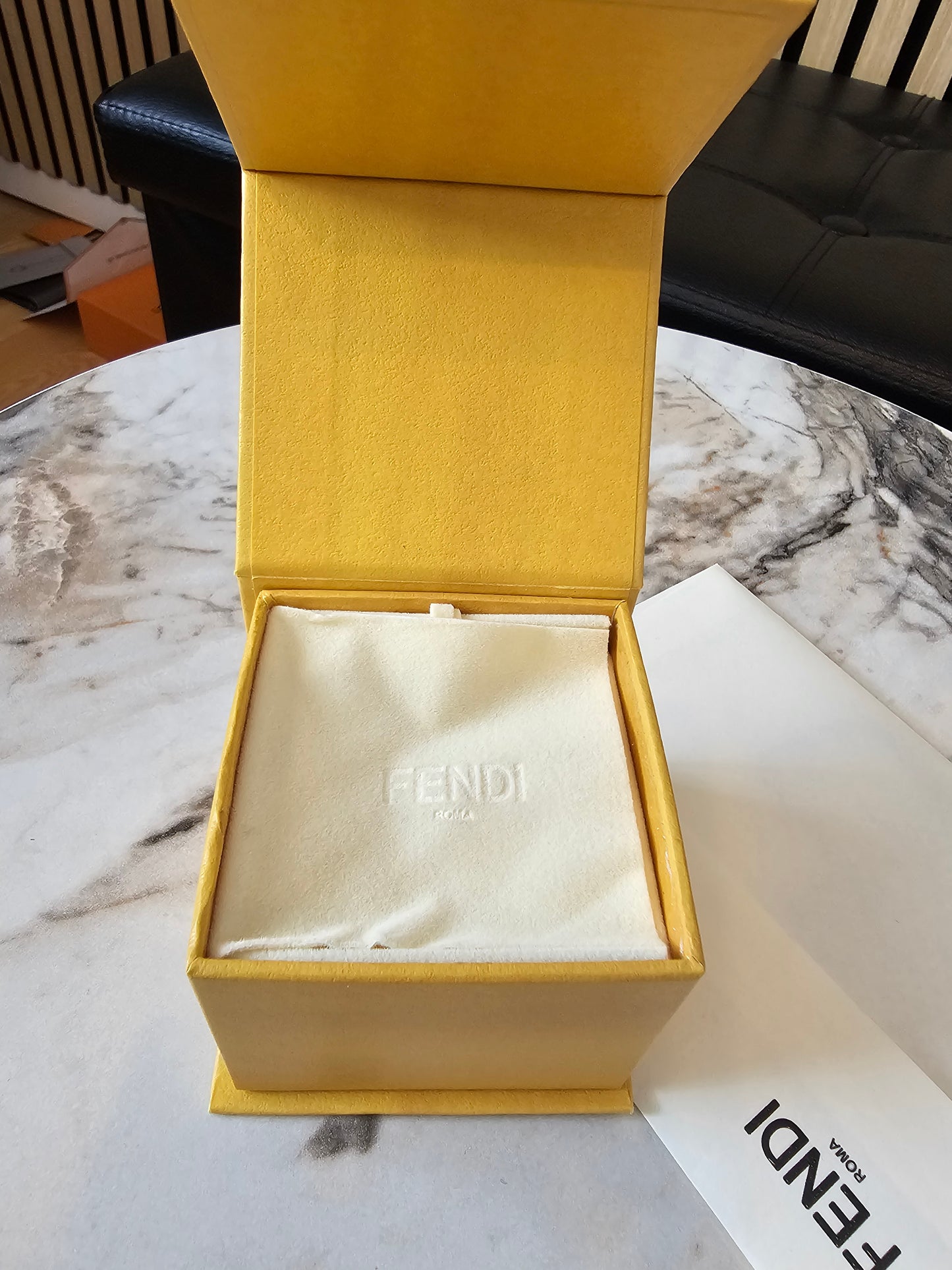 F- Fendi ring in golden with stones.