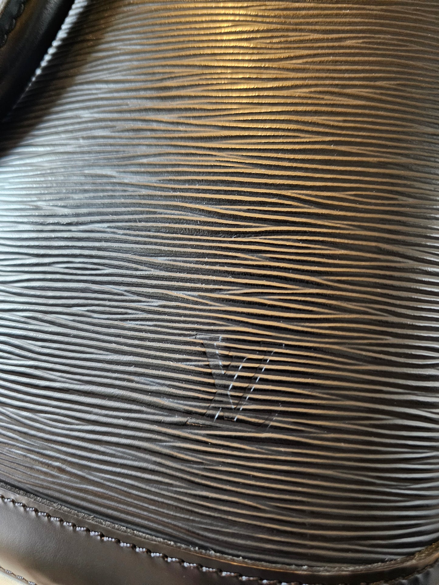 Louis Vuitton Alma PM with adjustable shoulder strap.