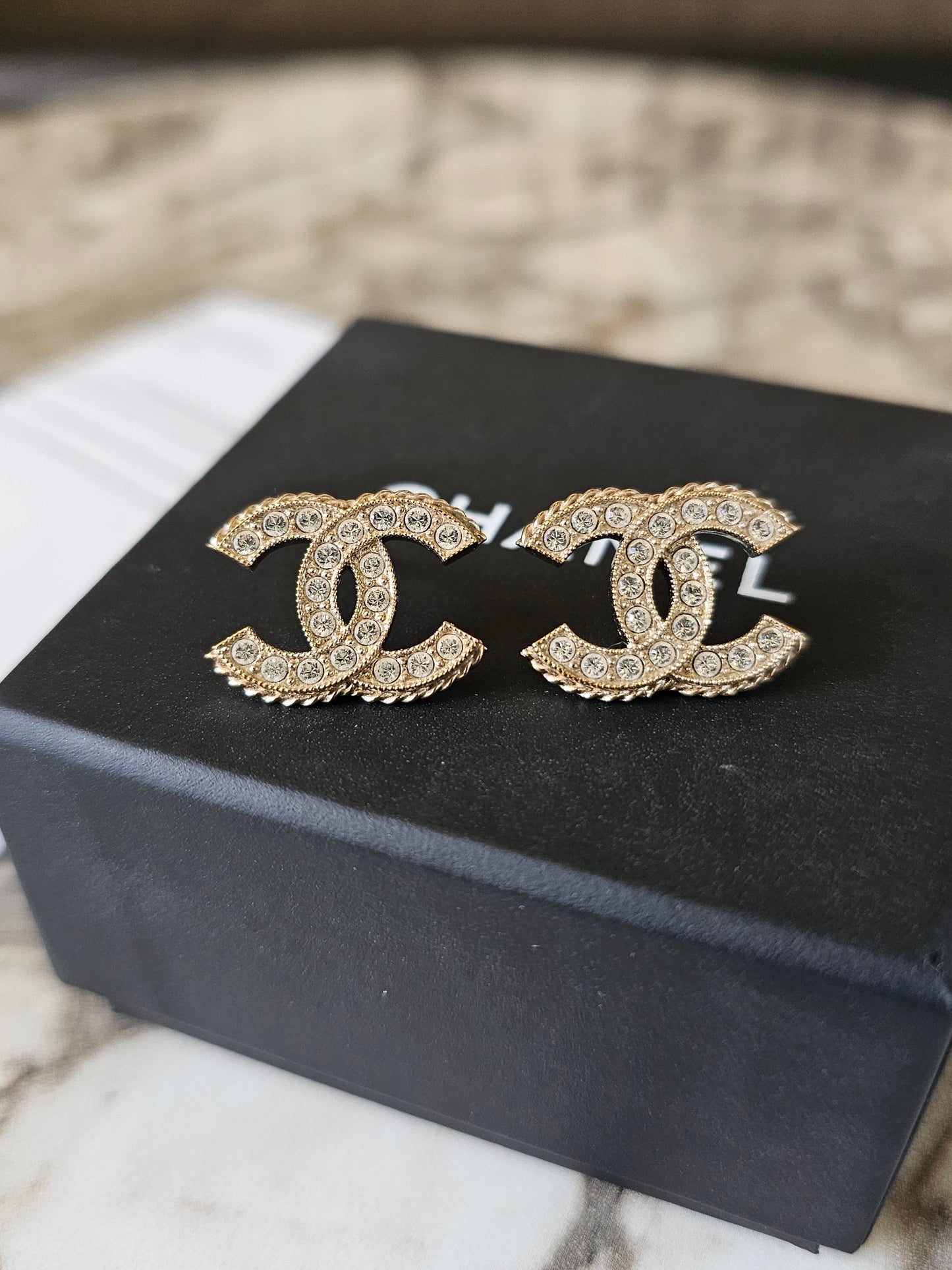 Chanel earrings, golden cc with stones.