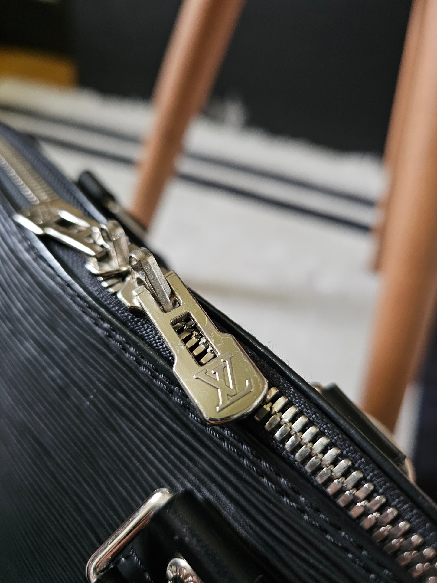 Louis Vuitton Alma PM with adjustable shoulder strap.