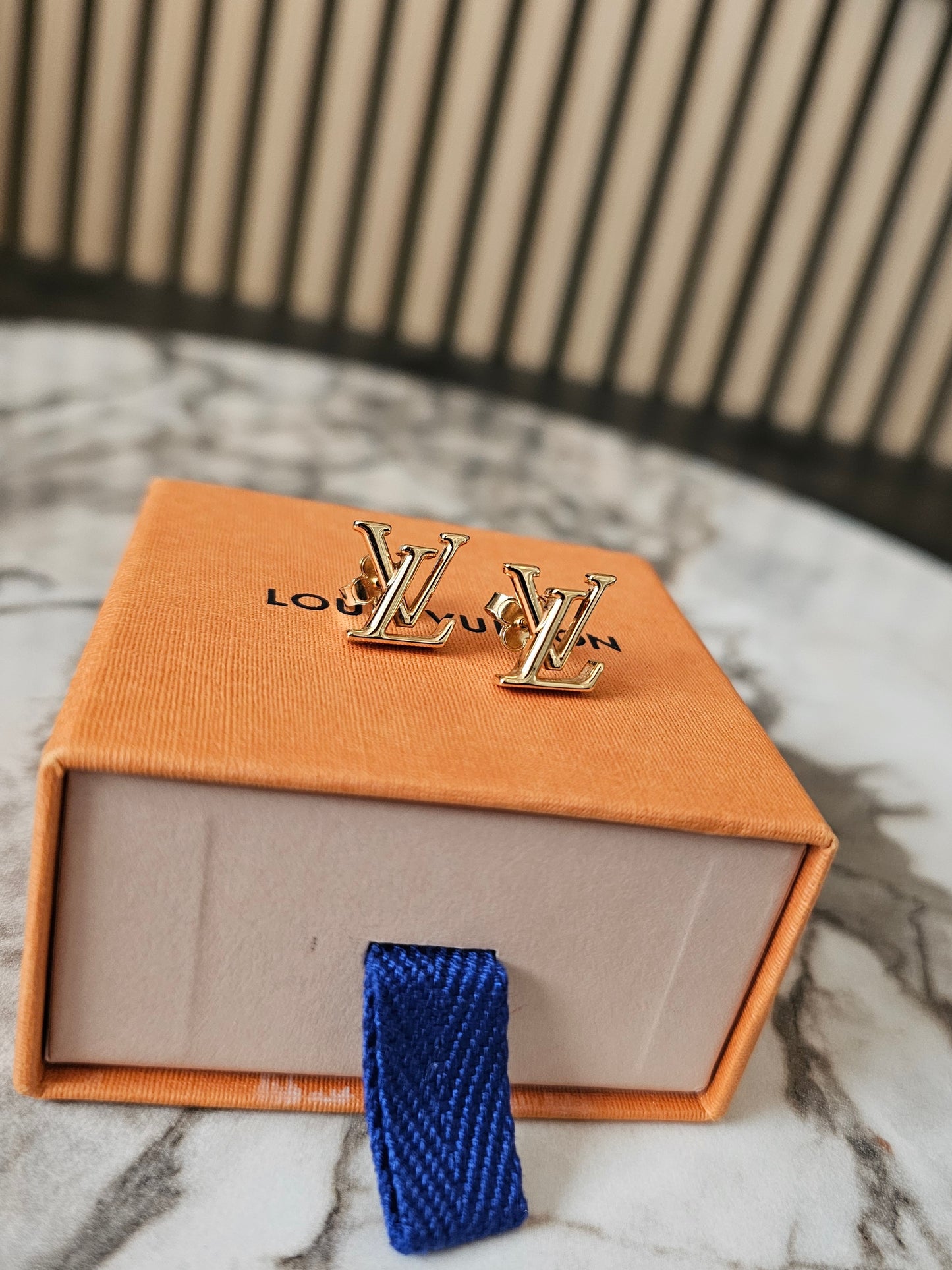 Louis Vuitton , iconic LV earrings, golden.