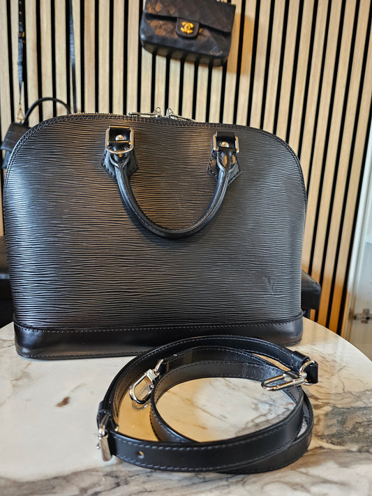 Louis Vuitton Alma PM with adjustable shoulder strap.