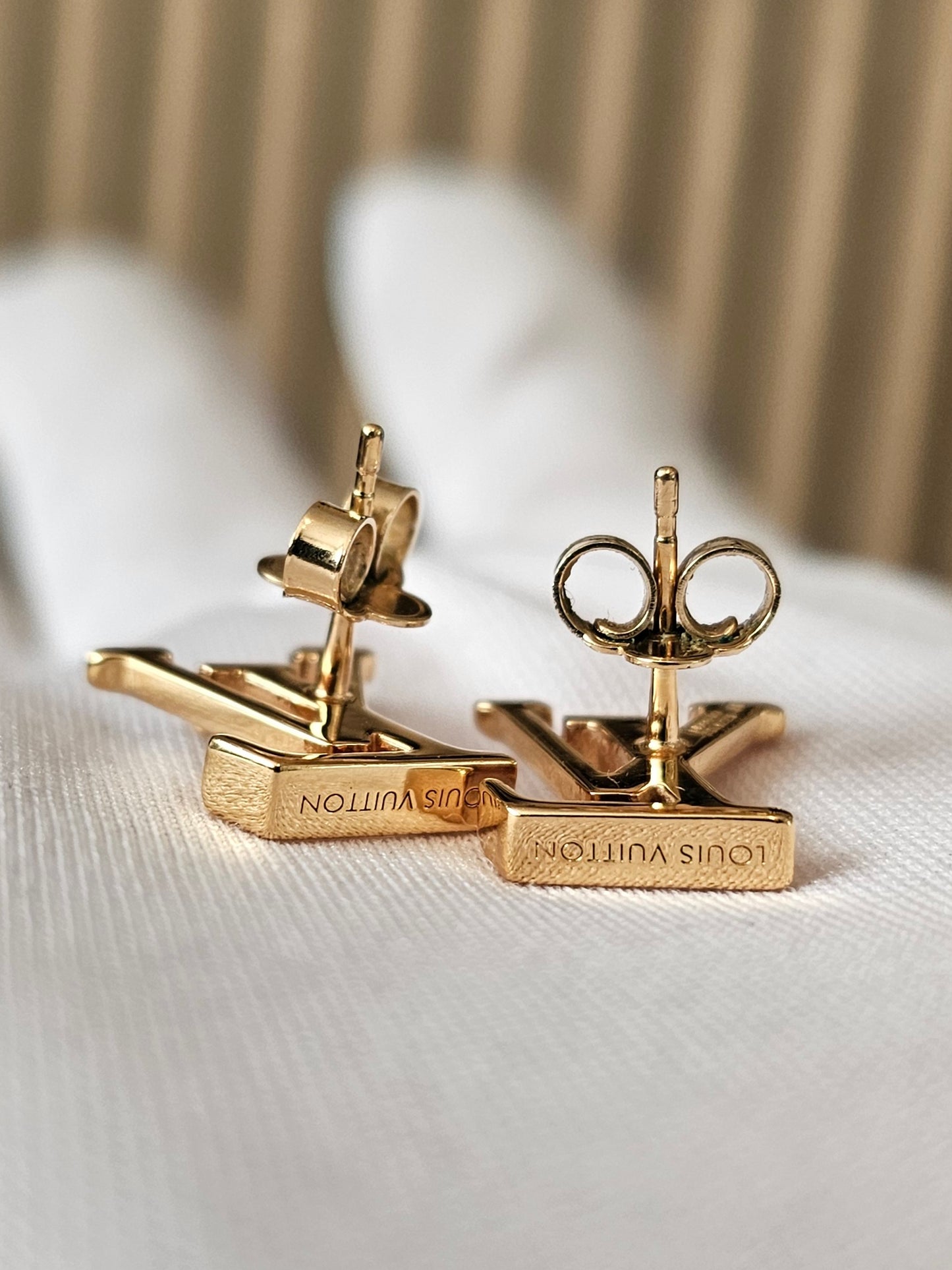 Louis Vuitton , iconic LV earrings, golden.