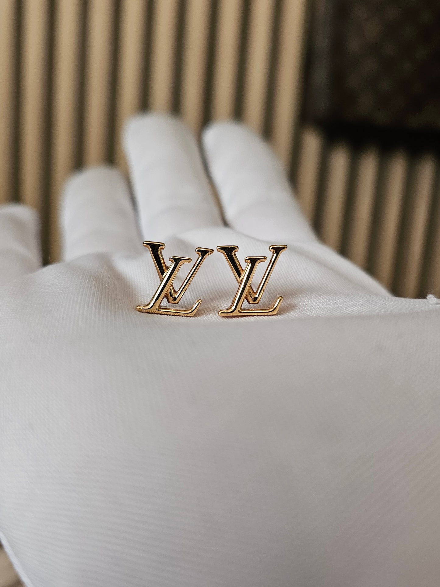 Louis Vuitton , iconic LV earrings, golden.