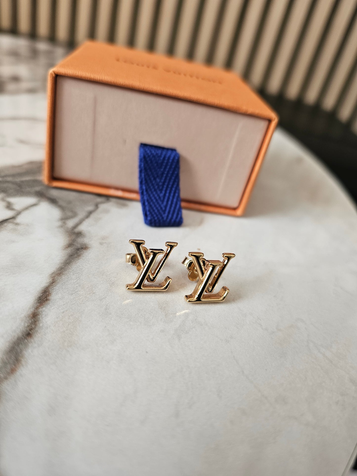 Louis Vuitton , iconic LV earrings, golden.